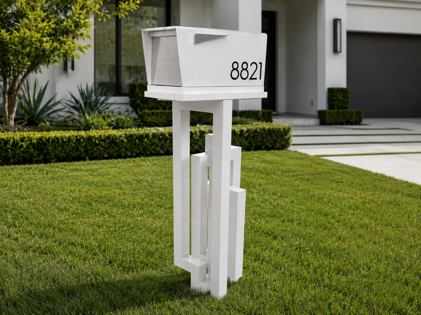 White modern aluminum mailbox with a geometric custom post and black house numbers at a contemporary home.
